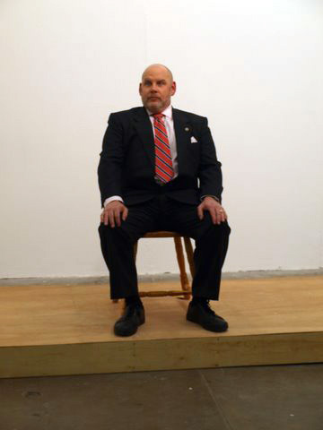 John G Boehme: <em>Dais (chaos with chair)</em>, sitting on the chair, posing, 2010, performance shot, <em>CHAOS</em>; photo Jordan Hutchings; courtesy CHAOS” width=”320″><br /><br>
<div class=